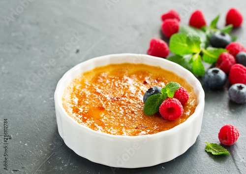 Creme brulee. dessert with caramel crust and berries.