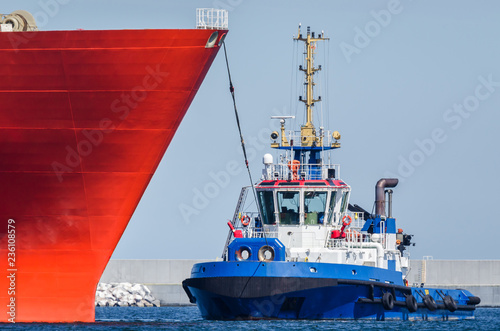 TUGBOAT AND SHIP - Ships maneuver in the port