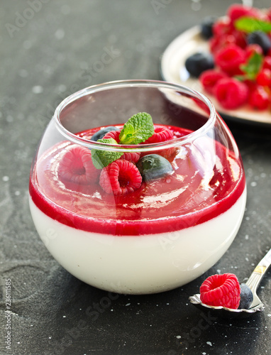 Delicious Italian dessert panna cotta with berries and berry sauce. Valentine's Day.