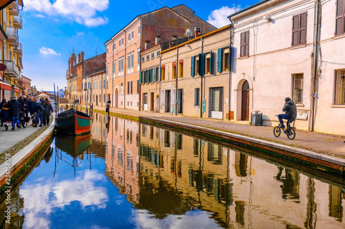 Comacchio vale Ferrara province Emilia Romagna region cycling in Italy blue sky over canal
