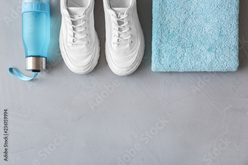 Flat lay composition with fitness equipment and space for text on gray background
