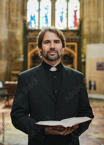 Christian priest standing by the altar