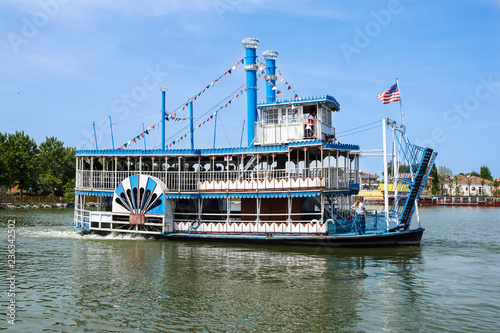 Vintage paddlwheel steamboat painted in old-fashioned American in the river