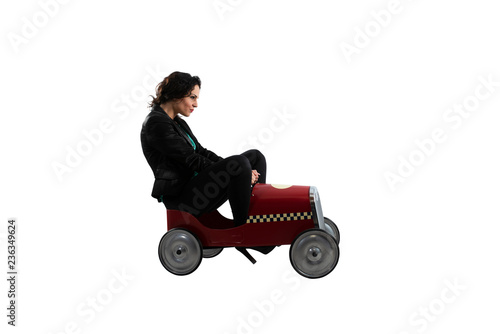 Businesswoman drives a toy car. Isolated on white background