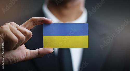 Businessman Holding Card of Ukraine Flag