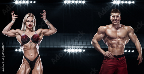 Bodybuilding competitions on the scene. Men and women sportsmens and athletes. Black background with lights.