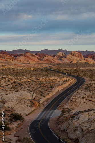 Aerial view on the scenic road in the desert during a cloudy sunrise. Taken in Valley of Fire State Park, Nevada, United States.