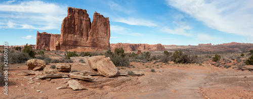 Panoramic landscape view of beautiful red rock canyon formations during a vibrant sunny day. Taken in Arches National Park, located near Moab, Utah, United States.