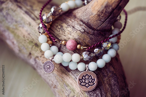Three natural mineral stone beads bracelet on wooden background