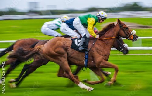 Close-up of jockey and race horse in action, speeding fast motion blur