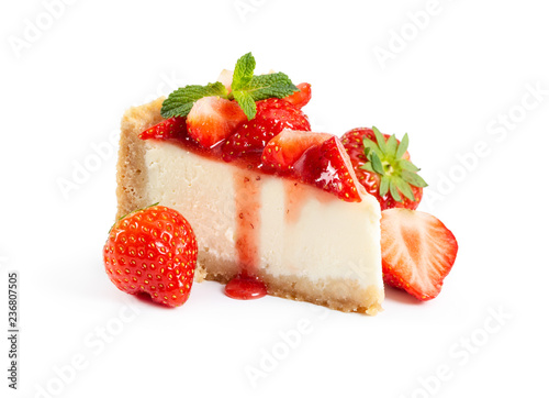 Piece of cheesecake with fresh strawberries and mint