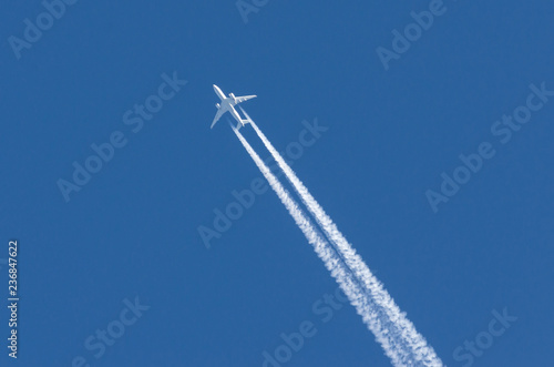 White aircraft big two engines aviation airport contrail clouds.