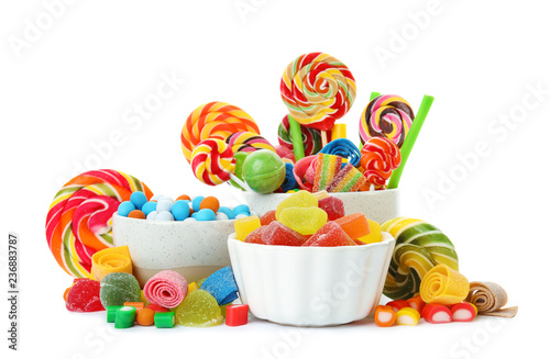 Composition with many different yummy candies on white background