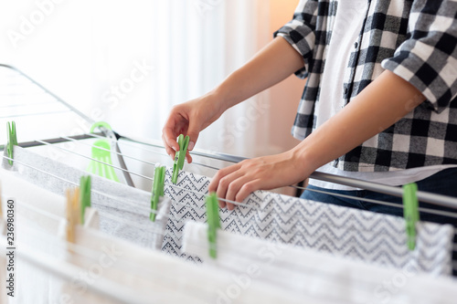Woman hanging wet clothes to dry