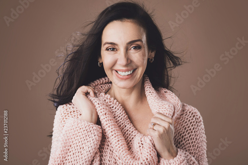 Portrait of beautiful middle aged woman wearing warm woolen sweater