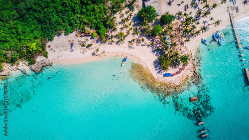 Aerial drone view of Saona Island in Punta Cana, Dominican Republic with reef, trees and beach in a tropical landscape with boats and vegetation