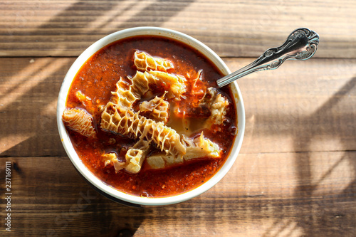 Beef tripe soup on wooden table