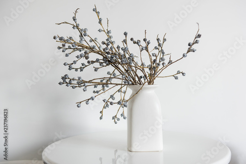 Minimal elegant composition with dried flowers on table. Vase of dried flowers with white wall background.