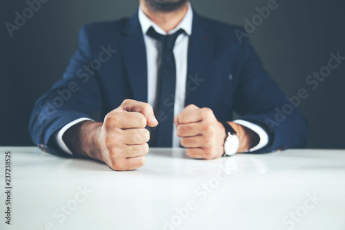 man fists on table