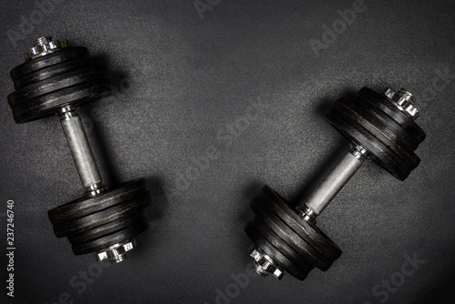 Gym dumbbells on black background with copy sapce, Photograph taken from above