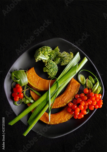 Salmon steak with delicious vegetables on wooden background