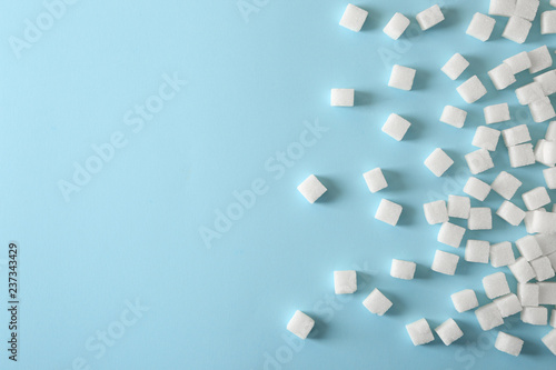 Refined sugar cubes on color background, top view