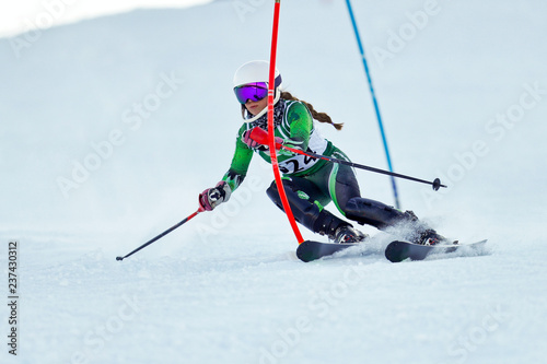 An alpine skier racing on the slalom course.