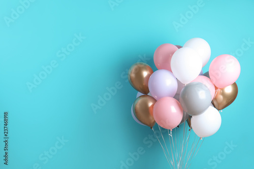 Colorful party balloons on blue background. Space for text