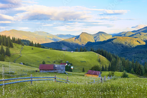 wooden houses and sheds in the mountain summer valley. natural nature