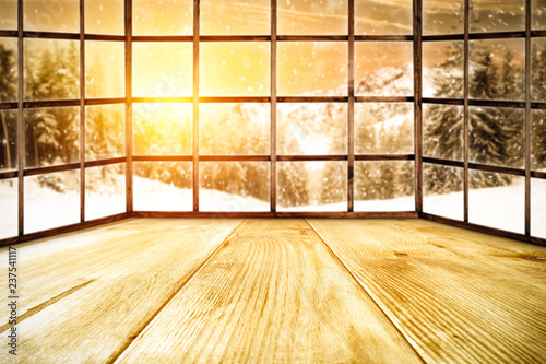 Winter window of wood and landscape of mountains and sunset time 