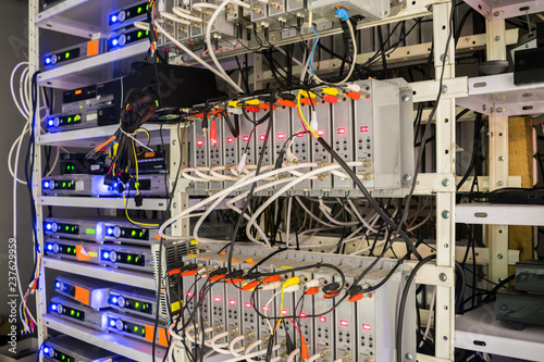 Many audio and video wires are connected to the distribution modules of the TV station. Rack with telecommunication equipment is in the server room of the data center