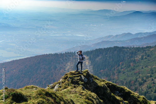 Young woman hiker enjoy the view at mountain peak