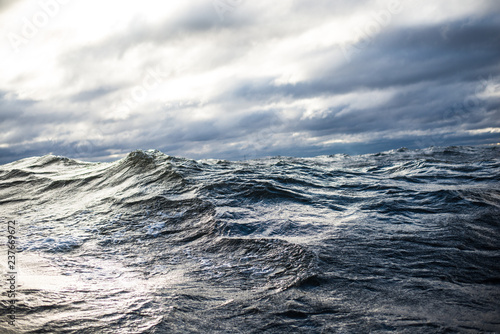 Winter sailing. Cold blue sea at sunset. waves and clouds, Norway