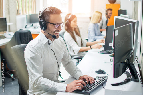 Young male technical support dispatcher in call center