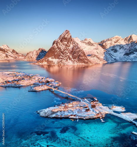 Aerial view at the Lofoten islands, Norway. Mountains and sea during sunset. Natural landscape from air at the drone. Norway at the winter time