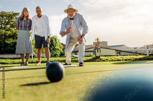 Group of senior people playing boules in a lawn