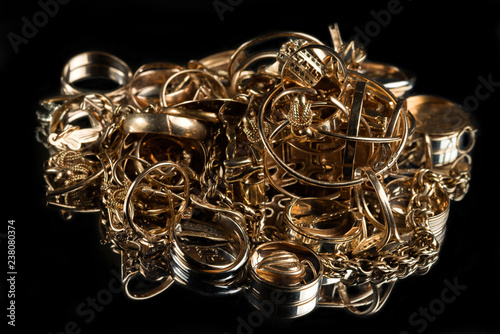 A scrap of gold. Old jewelry on a black background.