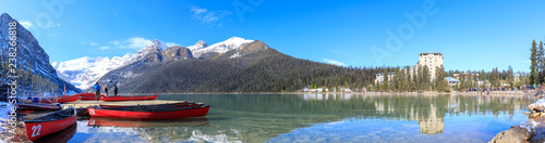 Red canoes at Lake Louise with rocky mountain in Banff national park