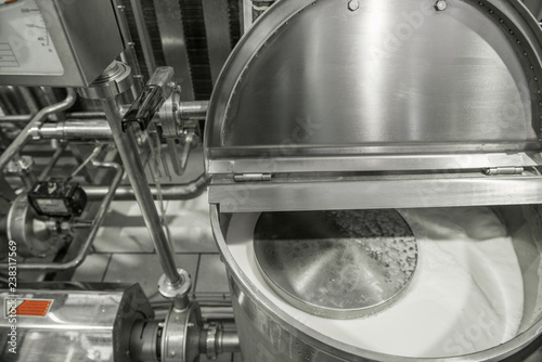 storage and pasteurization tank at the milk factory. equipment at the dairy plant