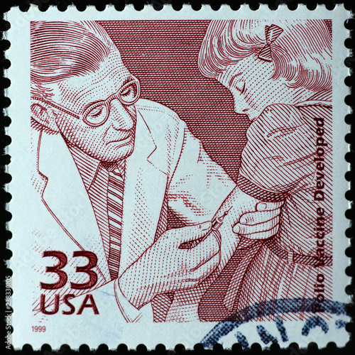 Doctor injecting polio vaccine on american postage stamp