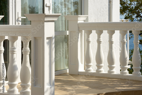 White concrete balustrade of small entrance porch.