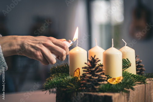 lighting a candle on advent wreath
