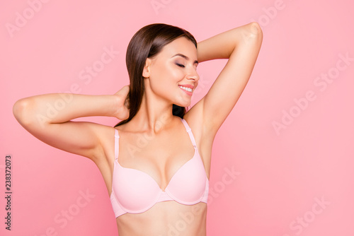 Close up portrait of gorgeous skinny cute lovely her she girl in salon relaxing of aroma sensitive procedure clear clean concept in bra eyes closed hands behind head isolated on pink background