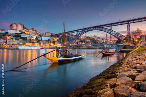 Porto, Portugal. Cityscape image of Porto, Portugal with reflection of the city in the Douro River and the Luis I Bridge during sunrise.