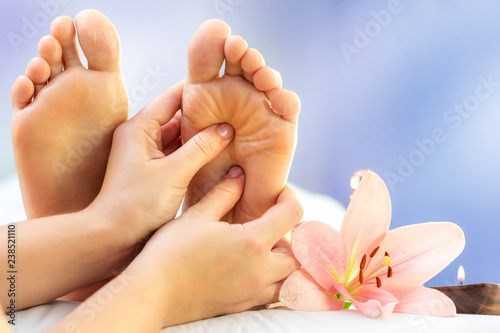 Close up reflexology massage on feet.