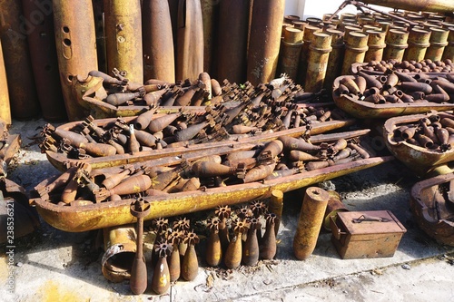 Rusted munitions, bomb housings and unexploded ordnance recovered and disarmed in rural Laos