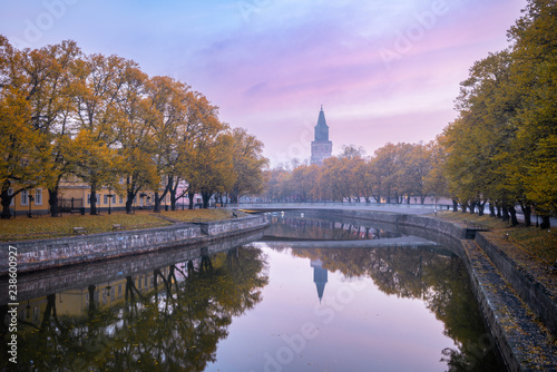 Aura river with beautiful fall foliage with Turku Cathedral in Turku Finland