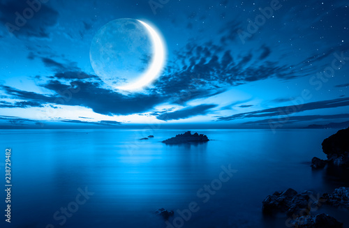 Night sky with moon in the clouds "Elements of this image furnished by NASA