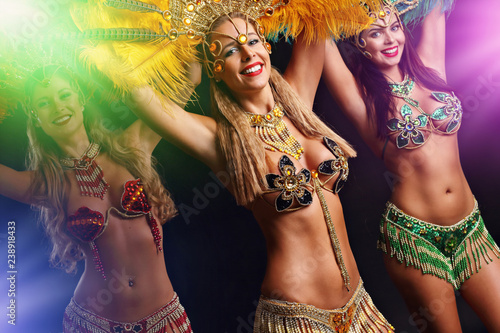 Brazilian women dancing samba over black background