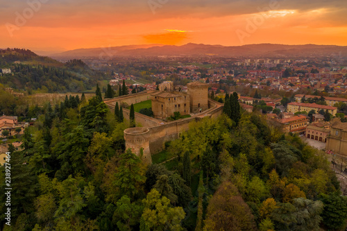 Sunset aerial panorama of Cesena in Emilia Romagna Italy near Forli and Rimini, with the medieval Malatestiana castle, Piazza del Popolo and Roman Catholic churches and cathedral on a winter afternoon